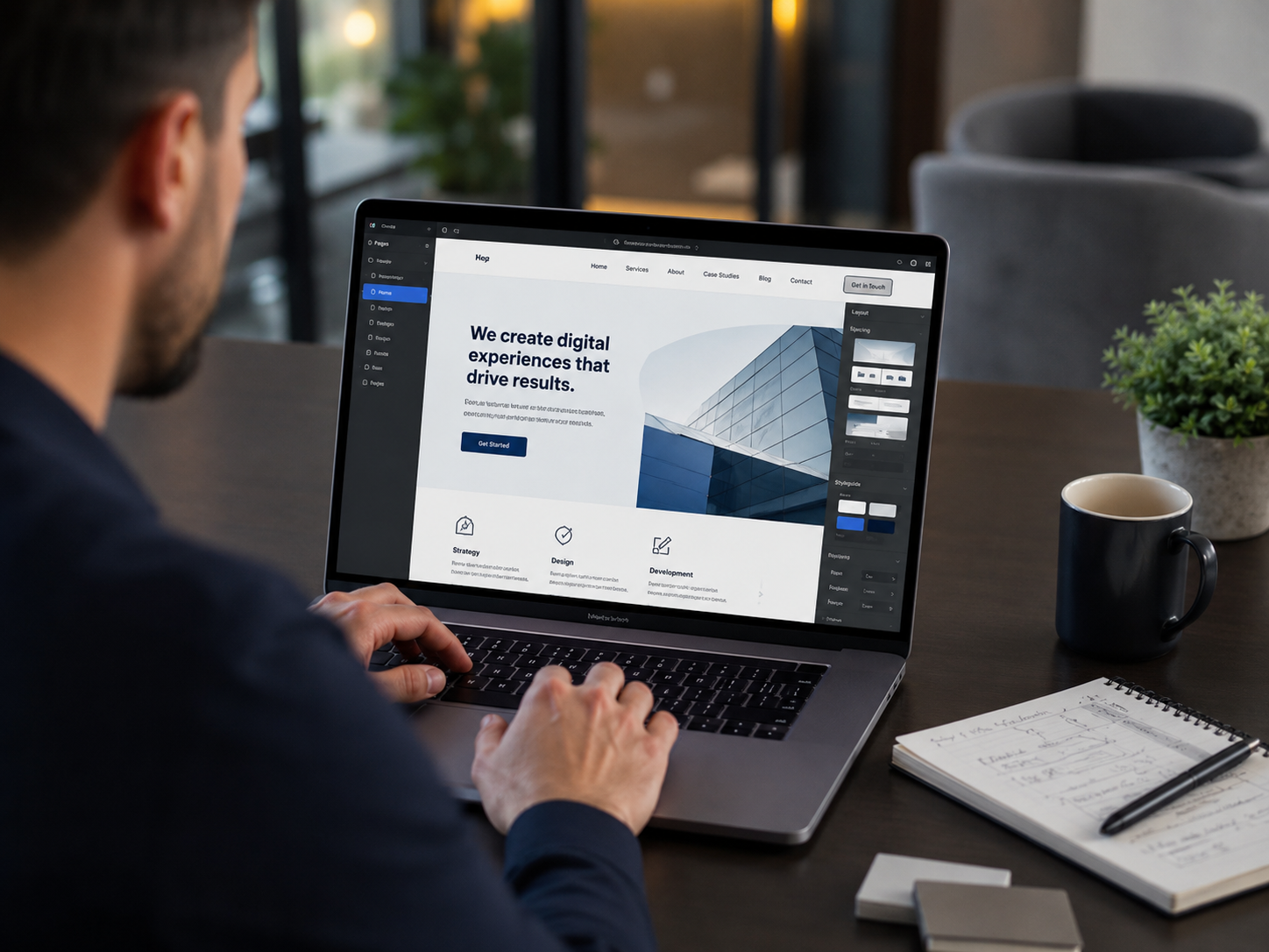 Digital studio website shown on laptop with developer working
